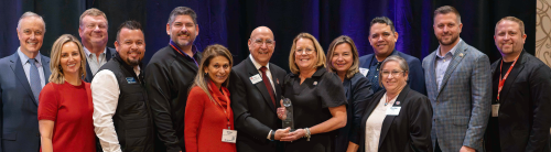 Adrian A. Arriaga receiving award with family and colleagues