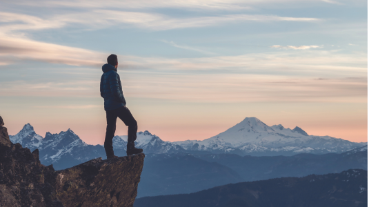 Man on a cliff contemplating his next steps