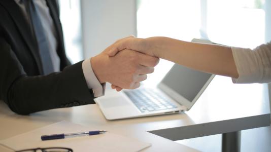 man and woman shaking hands