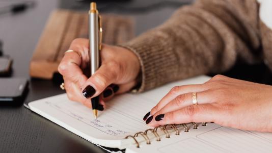 woman writing in a calendar